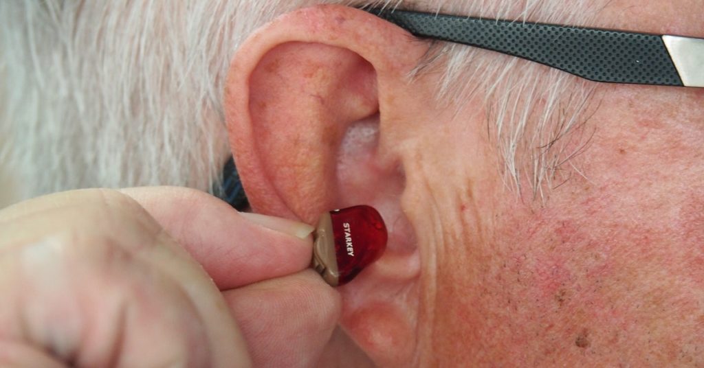 Inserting ear aid Essex